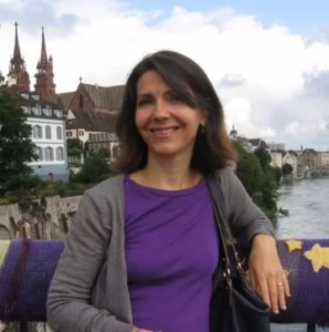 A woman in a purple shirt with dark hair