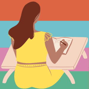 Woman seated at a desk writing in a notebook
