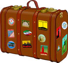 An old suitcase with many travel stickers.
