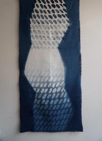 An indigo dyed and pattern textile.