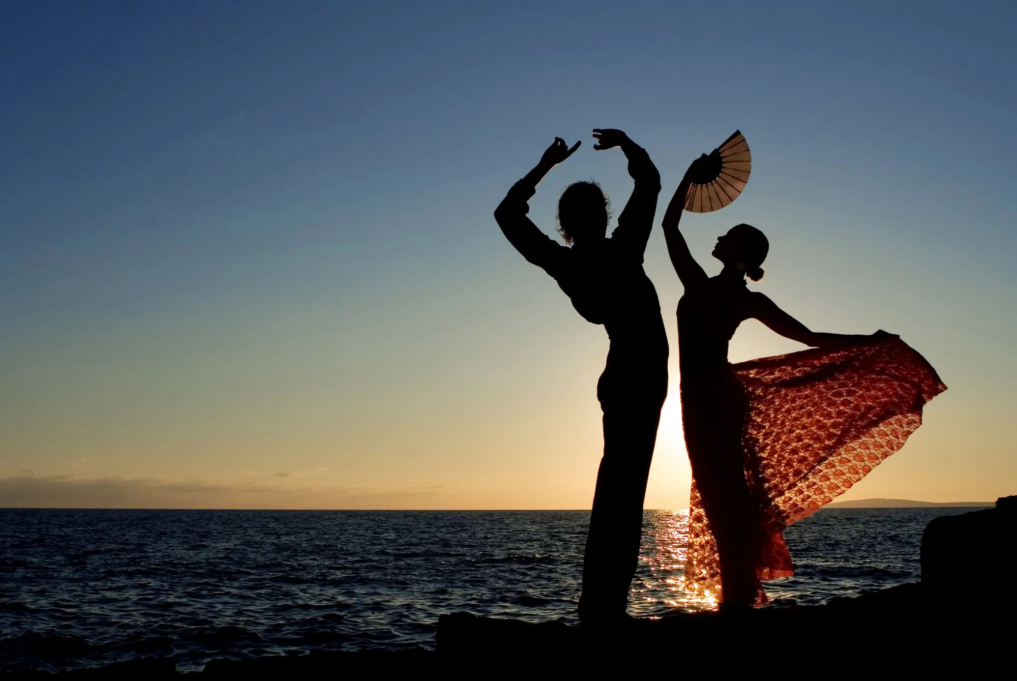 A silhouettes of a man and woman Flamenco dancers.