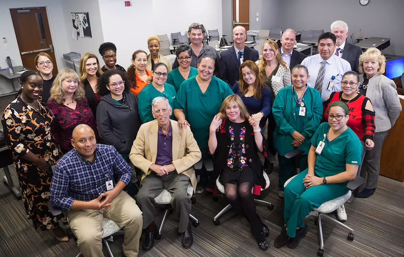 A large group of ESOL students who work in a hospital.