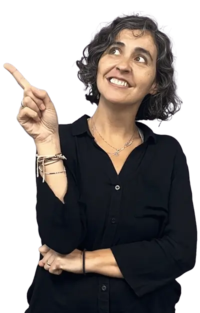 A woman pointing to something and smiling.