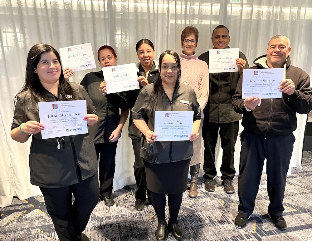 A group of employees from Marriott Hotel holding their certificates.