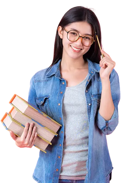 A young female student wearing classes smiling. She has a pencil in one hand and books in the other.