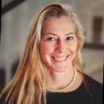 Woman with light hair smiling.