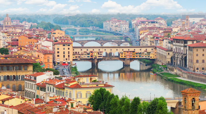 A broad view of Florence with the famous Ponte Vecchio over the Arno River, in Florence, Italy.