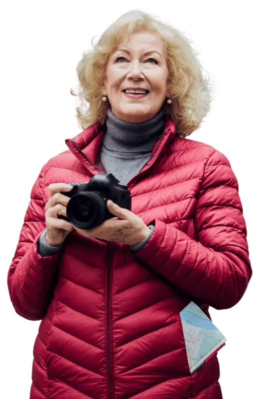 Woman in a red coat holding a camera