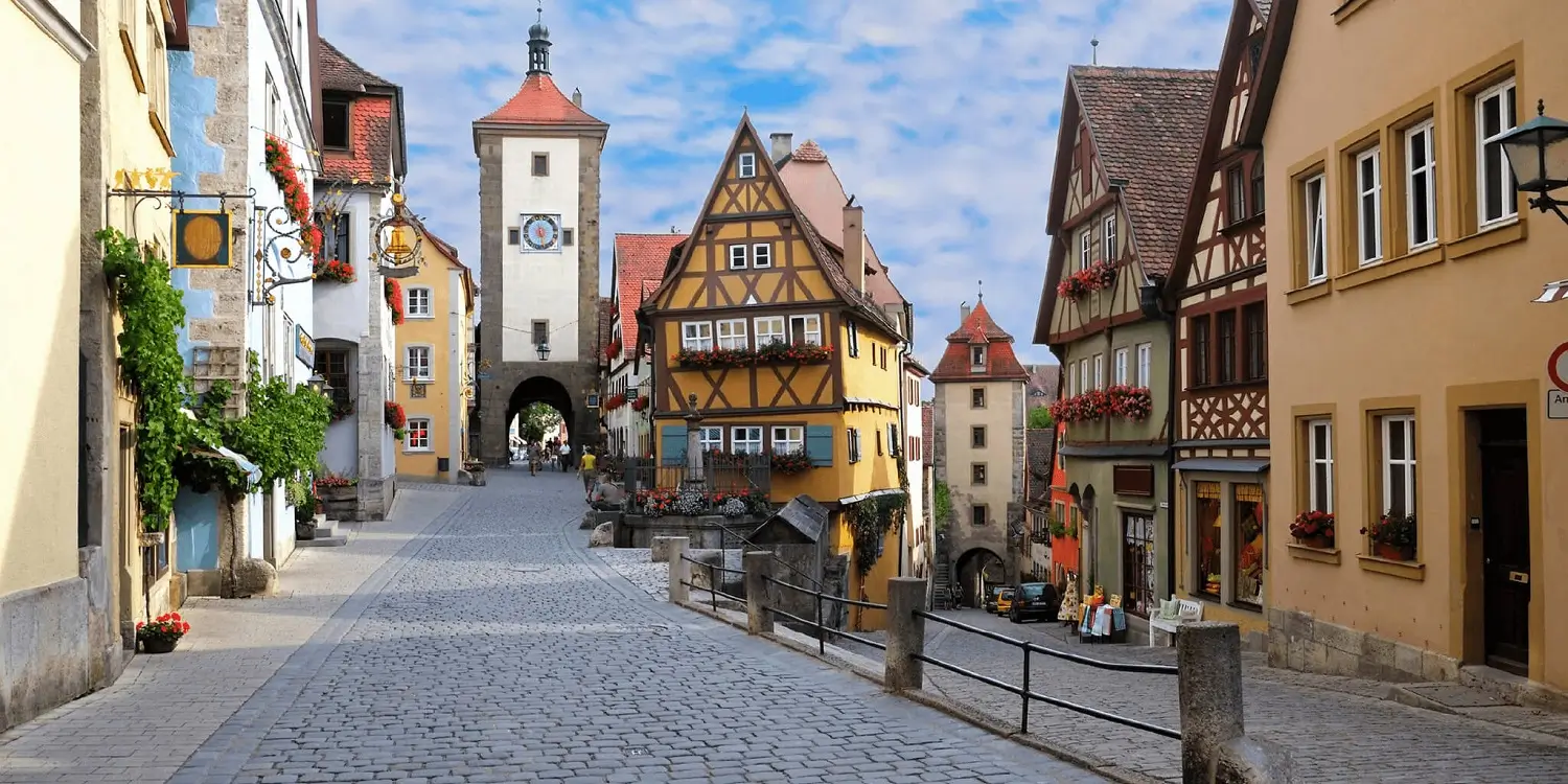 A charming cobblestone street in Germany lined with colorful buildings.