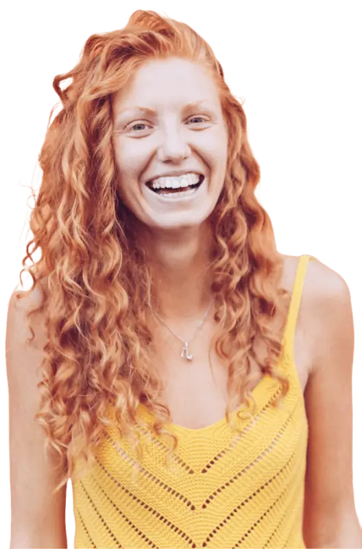 A smiling woman with red curly hair.