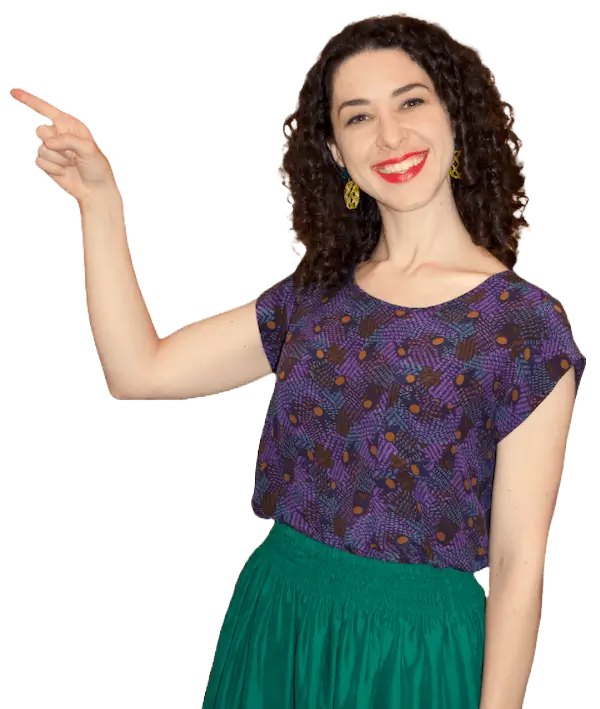 A woman in a purple top and green skirt, pointing.