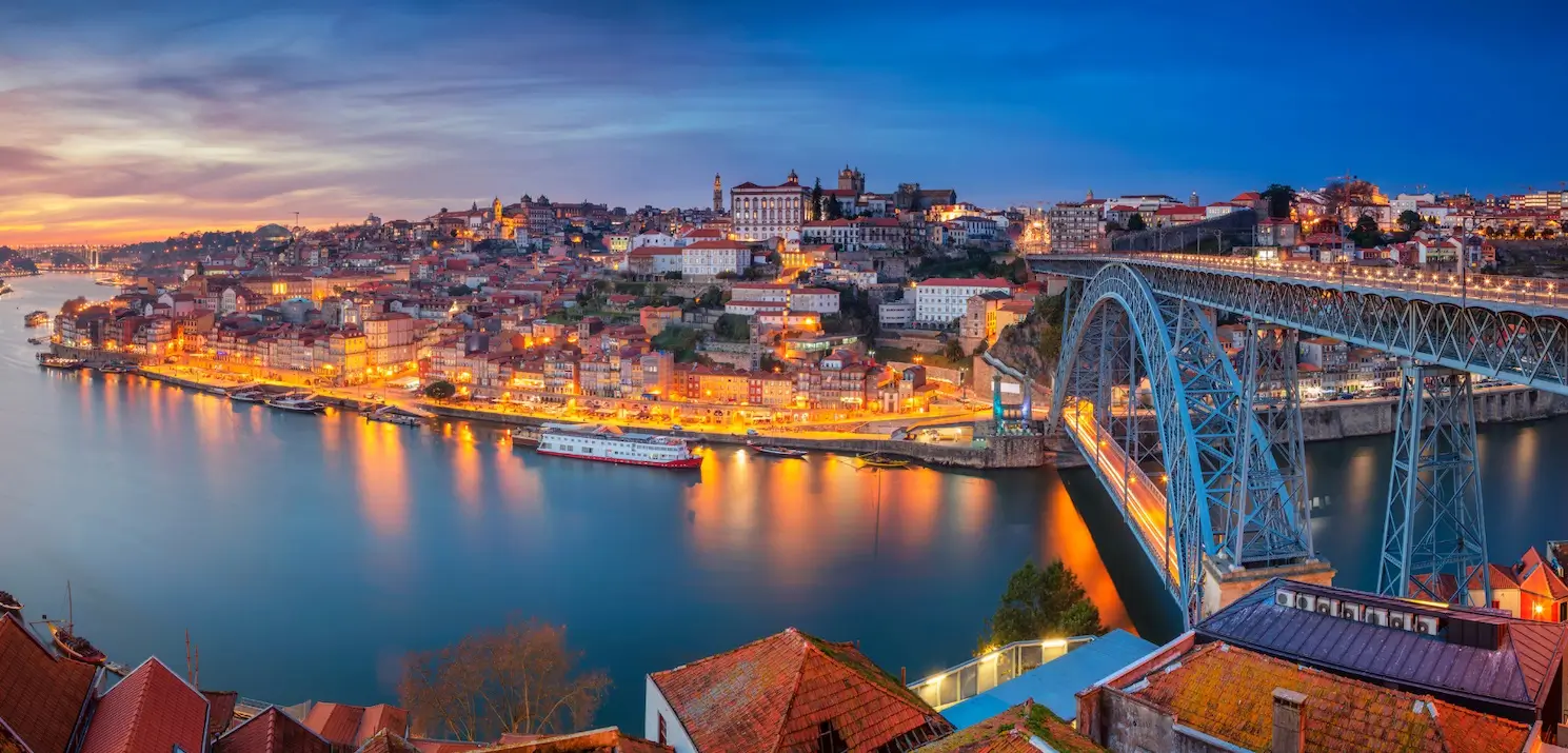 An evening view of a sunset over the picturesque town of Porto, Portugal.