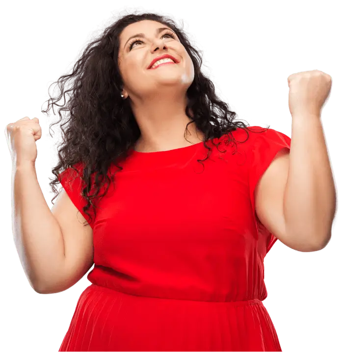 A woman wearing a red dress clinching her fists in excitement.