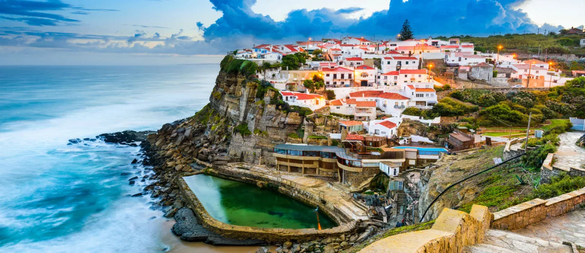 A panoramic view of Sintra, Portugal and the sweeping expanse of the Atlantic Ocean.