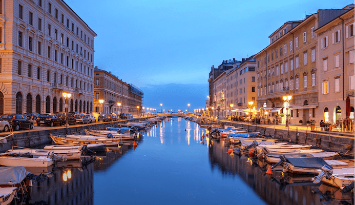 A scenic view of the Canal Grande in
Trieste, Italy at night.
