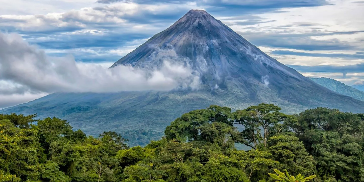 A view of the Arenal Volcano above the misty rainforest.