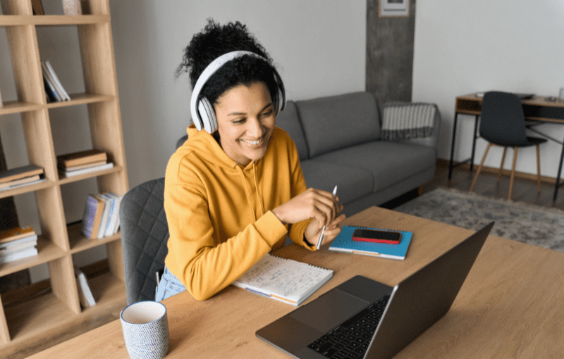 Young happy smiling African American adult student having virtual classes