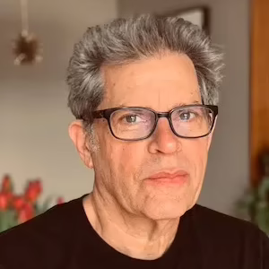Man with grey hair and glasses.