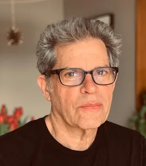 Man with grey hair and glasses.