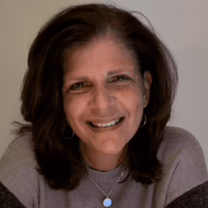 A woman with shoulder length dark hair smiling.