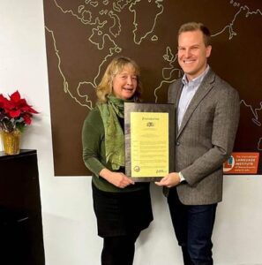 Markus Jones is shown in the picture with ILI Executive Director Caroline Gear and the Proclamation.