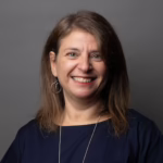 A woman looking at the camera and smiling