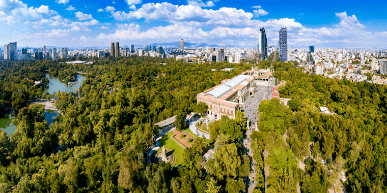 an aerial view of a city with a lake in the foreground