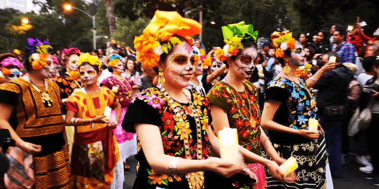 a group of women with face paint and flowers