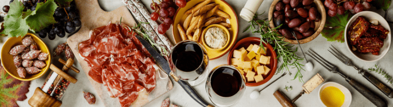 A beautifully arranged tapas table showcasing a variety of tasty dishes and wine.