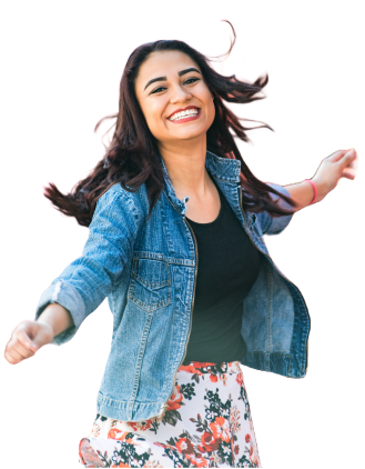 a woman wearing a jean jacket and floral skirt smiling