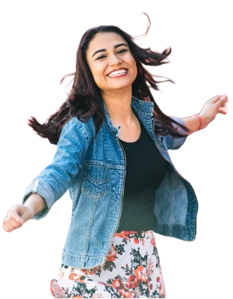 a woman wearing a jean jacket and floral skirt smiling