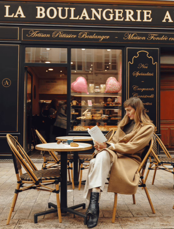 A woman at a table outside a cafe