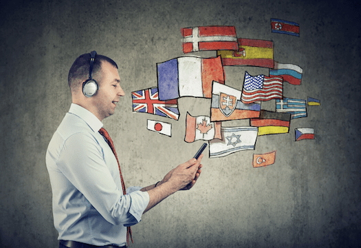 Man speaking into his phone with flags indicating other languages.