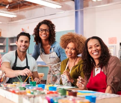 Four people participating in an art class.