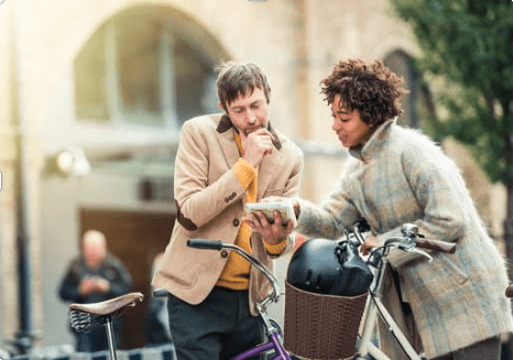 a woman giving directions to a man.
