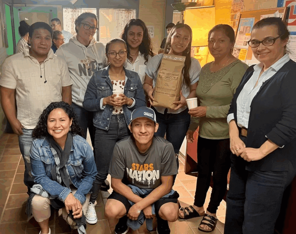 A group of students with a large bag of coffee.