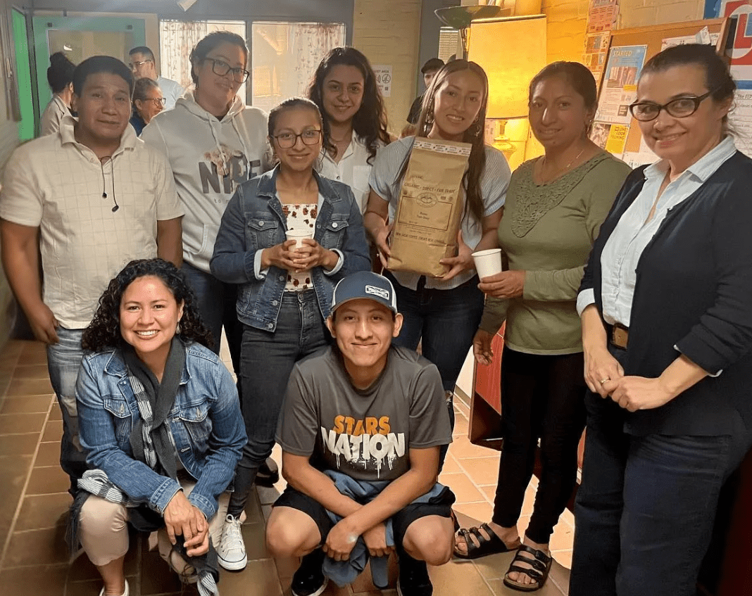 A group of students with a large bag of coffee.