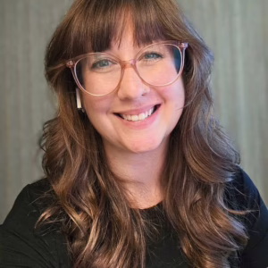 A smiling woman with glasses