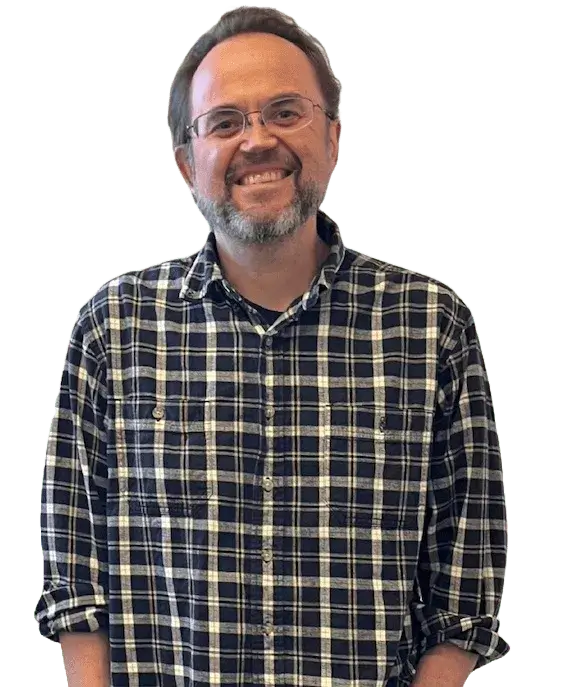 A man with a beard and glasses smiling.