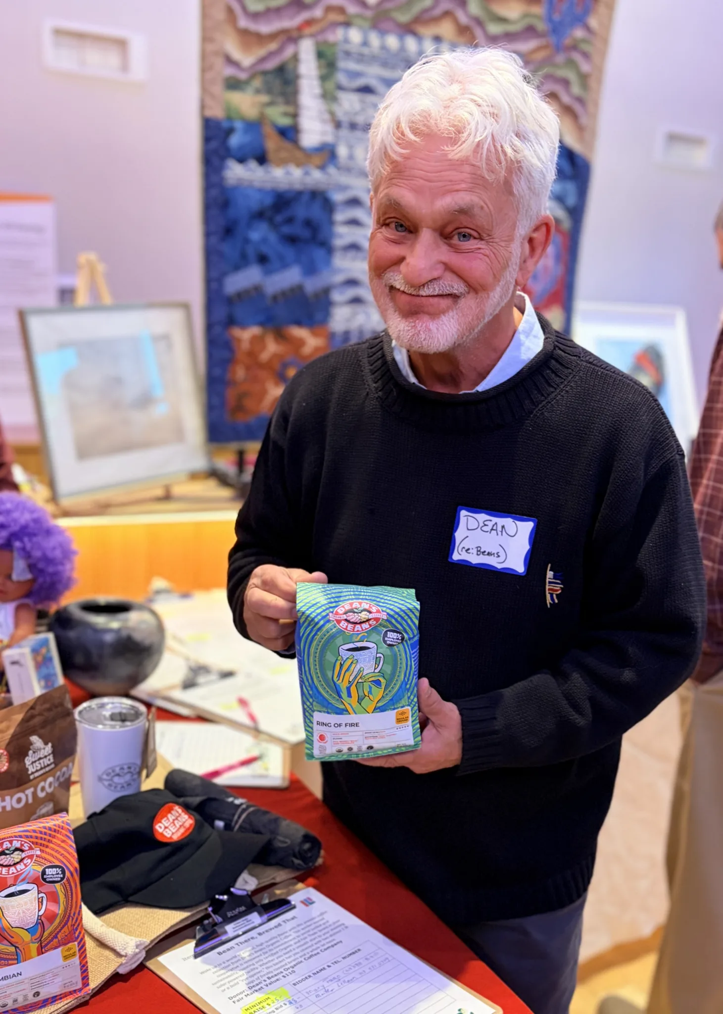 A man holding a bag of coffee.