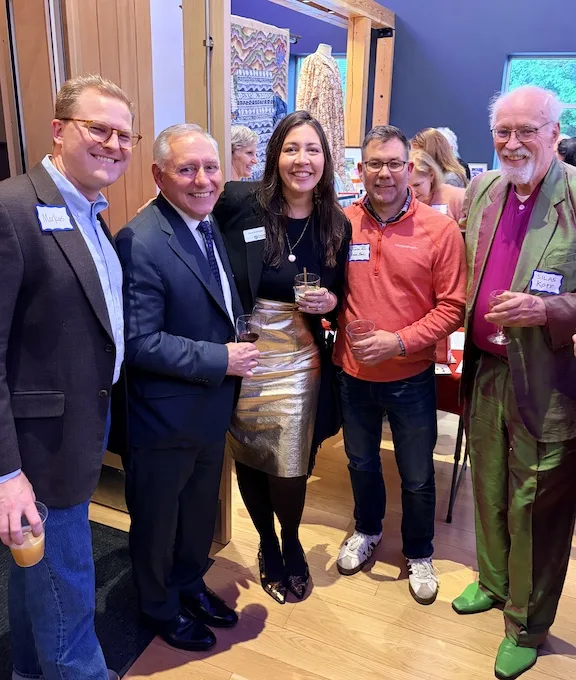 5 people at a party, smiling.