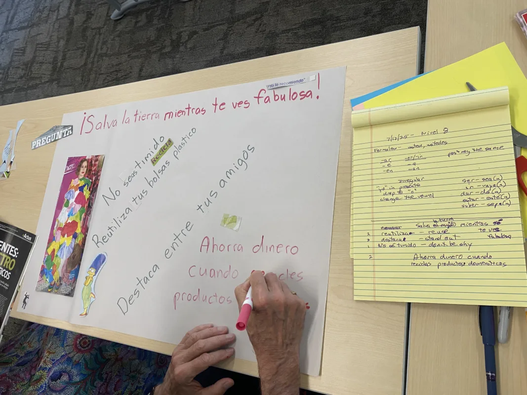 Students work on a collage with notes on command forms.
